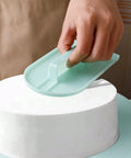 Smoothing buttercream on cake