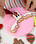 Piping royal icing on a cookie
