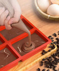 Filling silicone mini loaf mold with batter