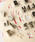 Letter cookie cutters in use on dough