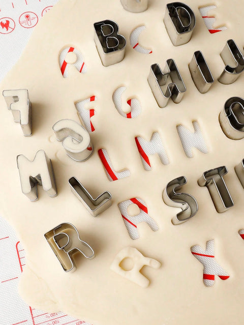Letter cookie cutters in use on dough