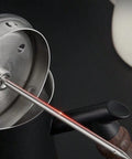 Thermometer probe in milk pitcher