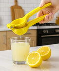 Squeezing lemon juice into glass