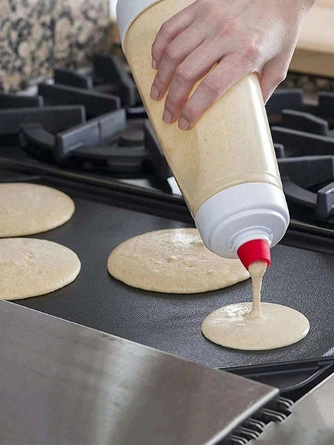 Pouring pancake batter on griddle