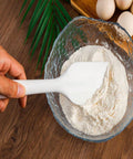 Mixing flour with silicone spatula