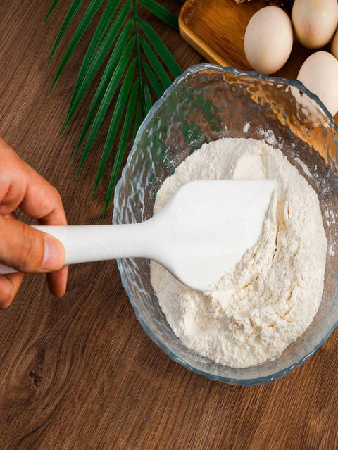 Mixing flour with silicone spatula