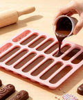 Pouring chocolate into long bar mold