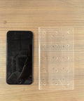 Acrylic stand next to a phone for scale