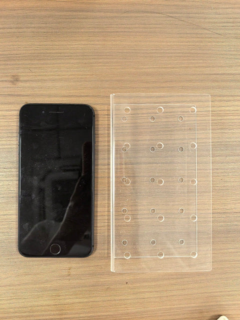 Acrylic stand next to a phone for scale