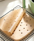 Perforated parchment sheets on rack
