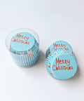Blue Christmas cupcake liners displayed beside their clear storage container