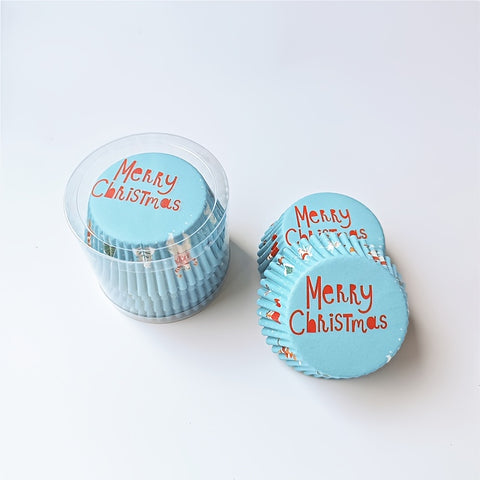 Blue Christmas cupcake liners displayed beside their clear storage container
