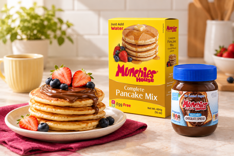 Munchies House 454g pancake mix and hazelnut chocolate spread beside pancakes with chocolate and berries.